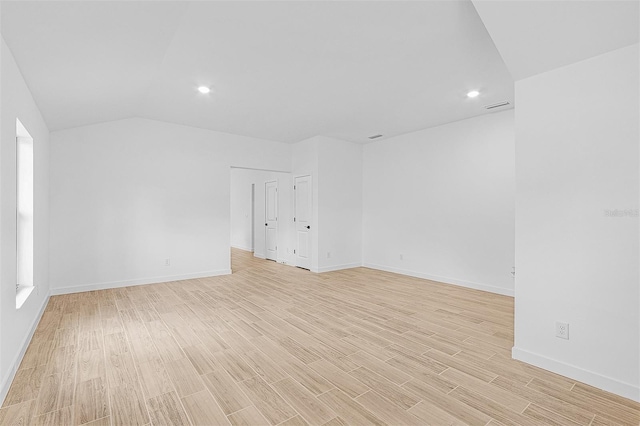 5237 Aberback St, North Port, FL 34291 - spare room featuring baseboards, visible vents, light wood-style flooring, and vaulted ceiling