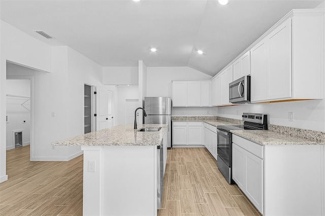 5237 Aberback St, North Port, FL 34291 - kitchen featuring an island with sink, light wood-style flooring, appliances with stainless steel finishes, and a sink