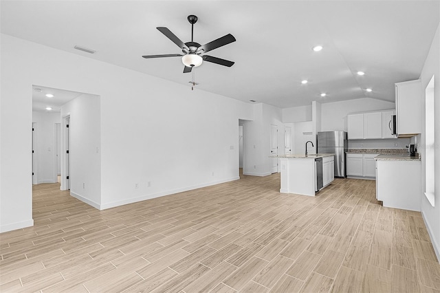 5237 Aberback St, North Port, FL 34291 - kitchen with open floor plan, stainless steel appliances, a center island with sink, ceiling fan, and visible vents