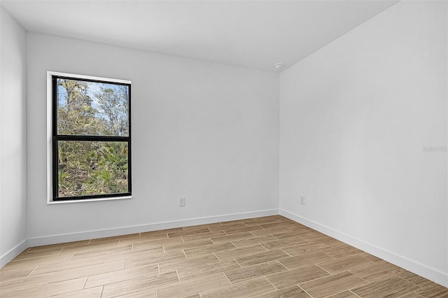 5237 Aberback St, North Port, FL 34291 - unfurnished room featuring wood tiled floor, baseboards, and a healthy amount of sunlight