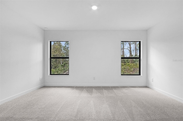 5237 Aberback St, North Port, FL 34291 - empty room with baseboards, carpet floors, and a healthy amount of sunlight