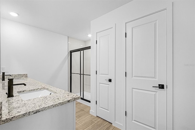 5237 Aberback St, North Port, FL 34291 - bathroom with double vanity, recessed lighting, wood tiled floor, a sink, and a stall shower