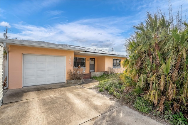 ranch-style house featuring a garage