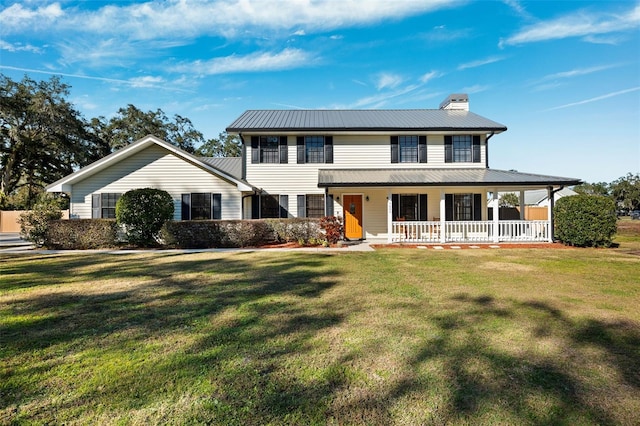 view of front of house with covered porch and a front yard