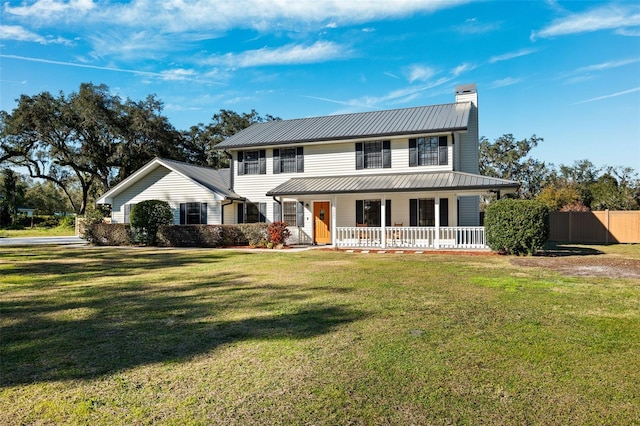 view of front of home with a porch and a front yard