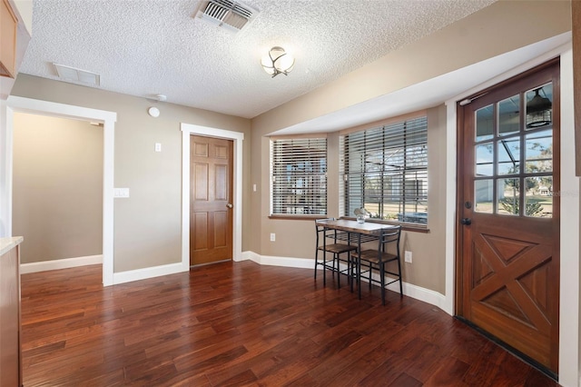 entryway featuring dark hardwood / wood-style floors and a textured ceiling