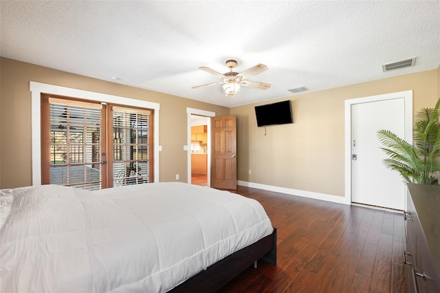 bedroom featuring access to outside, ceiling fan, dark wood-type flooring, a textured ceiling, and french doors