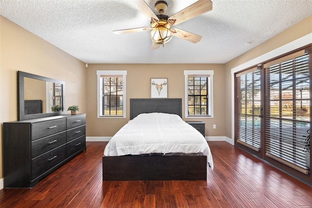 bedroom featuring dark hardwood / wood-style floors, a textured ceiling, and ceiling fan