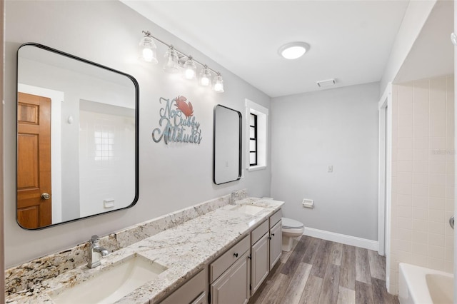 full bathroom with shower / tub combination, vanity, toilet, and hardwood / wood-style floors