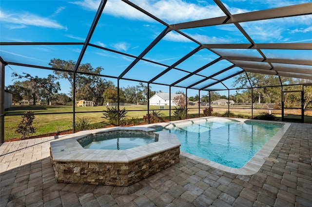 view of pool featuring a lanai, a patio area, and an in ground hot tub