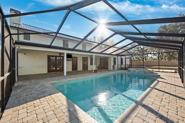 view of swimming pool with an in ground hot tub, a lanai, ceiling fan, and a patio