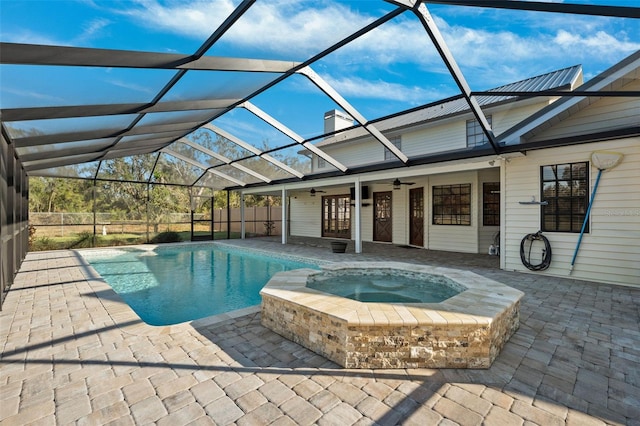 view of swimming pool featuring an in ground hot tub, a lanai, ceiling fan, and a patio area