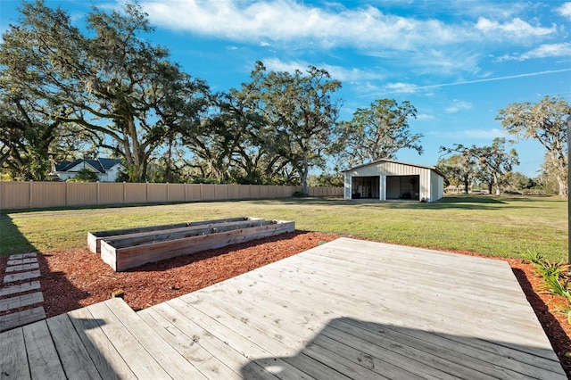 wooden terrace with an outbuilding, a yard, and a garage