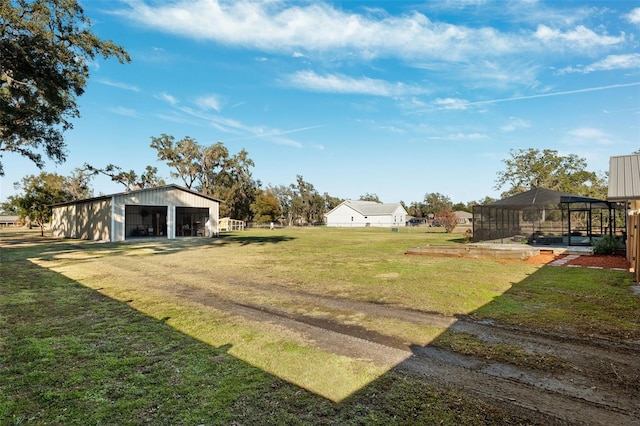 view of yard with an outdoor structure and glass enclosure