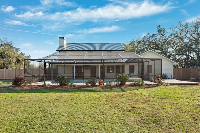 back of property featuring a lanai, a patio, and a lawn