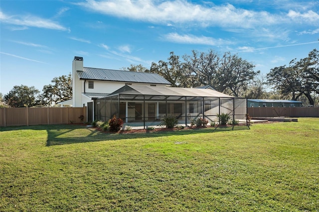 back of property with a swimming pool, glass enclosure, and a lawn