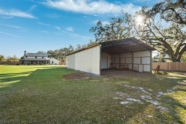 view of outbuilding featuring a yard