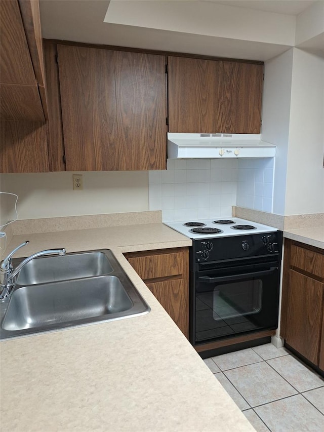 kitchen with black range with electric stovetop, sink, light tile patterned floors, and backsplash