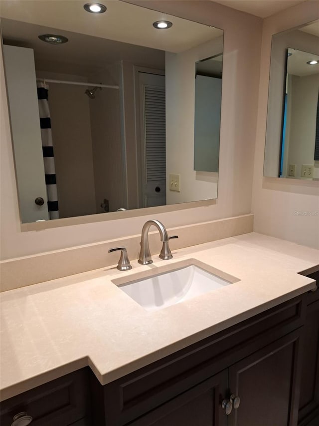 bathroom featuring vanity and a shower with shower curtain