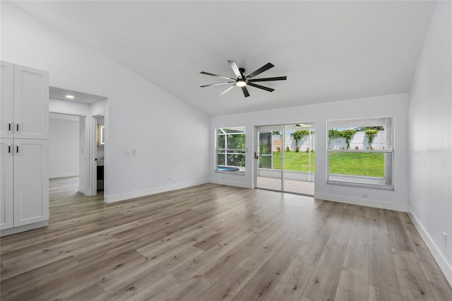 unfurnished living room featuring lofted ceiling, light hardwood / wood-style floors, and ceiling fan