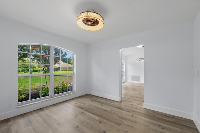 spare room featuring light hardwood / wood-style flooring