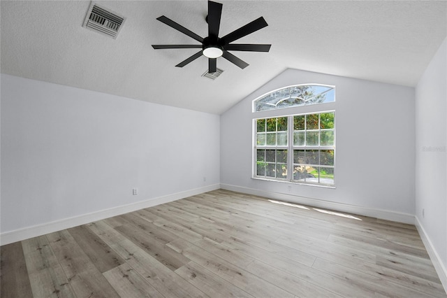 interior space featuring lofted ceiling, a textured ceiling, light hardwood / wood-style flooring, and ceiling fan