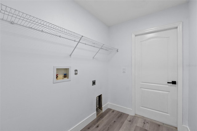 washroom featuring hookup for a washing machine, light hardwood / wood-style floors, and hookup for an electric dryer