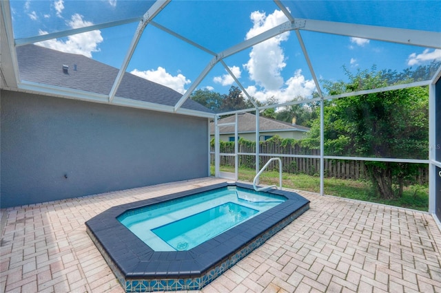 view of pool featuring an in ground hot tub, a lanai, and a patio area