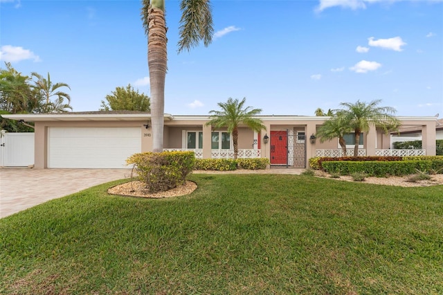 single story home featuring a garage and a front yard