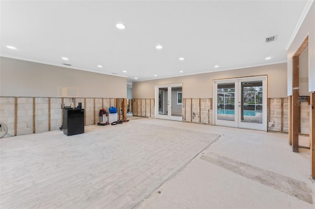 interior space with ornamental molding and french doors