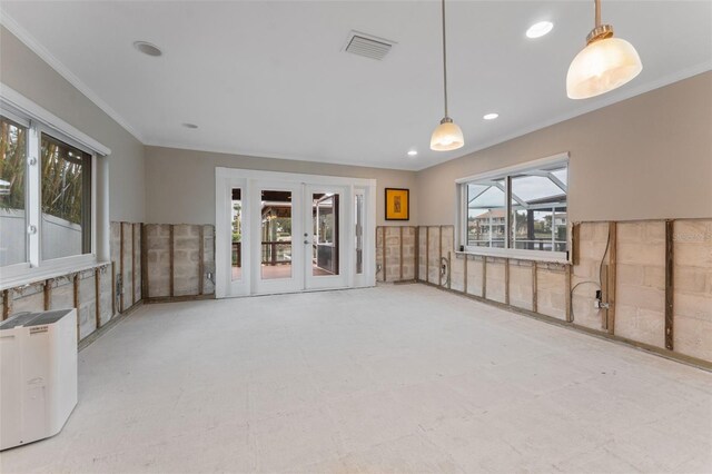 unfurnished living room featuring french doors and ornamental molding