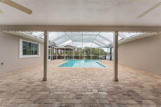 view of swimming pool featuring a lanai and a patio area