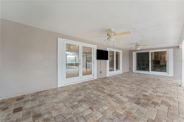 view of patio with french doors and ceiling fan