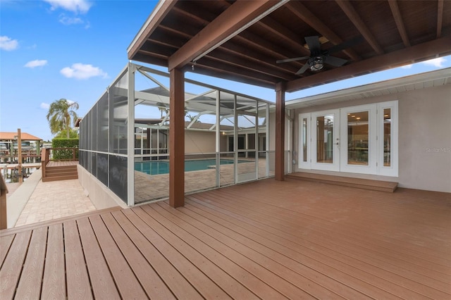 wooden terrace featuring french doors, ceiling fan, a lanai, and a patio area