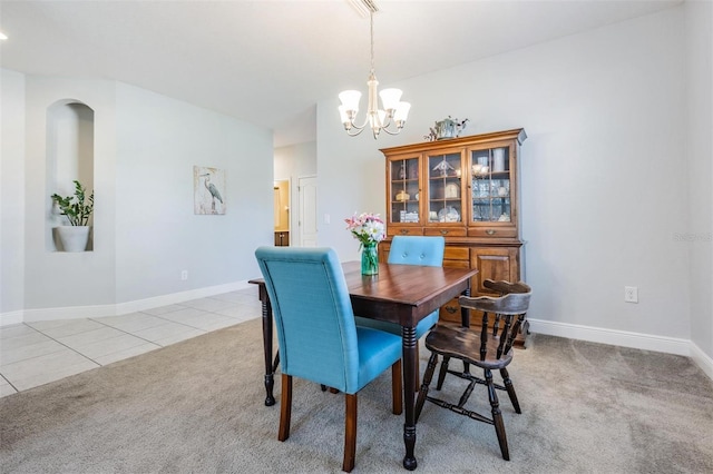 dining area featuring light tile patterned flooring and an inviting chandelier