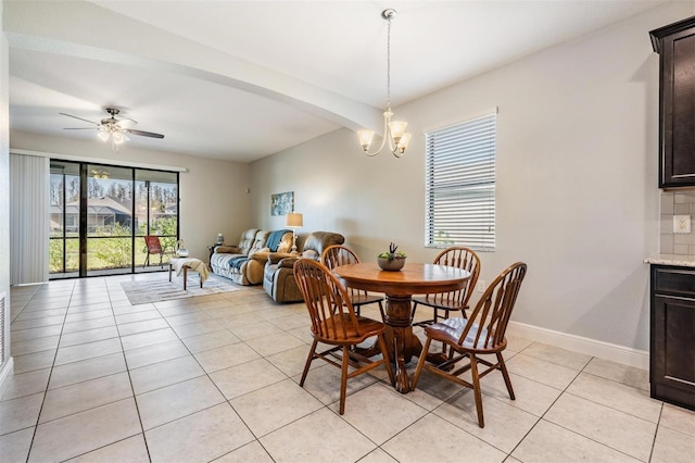 tiled dining area featuring beam ceiling and ceiling fan with notable chandelier