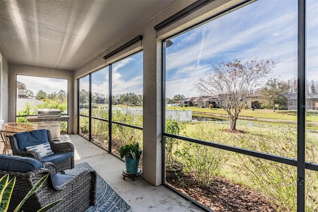 sunroom / solarium with a water view