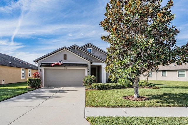 view of front of house with a garage and a front lawn