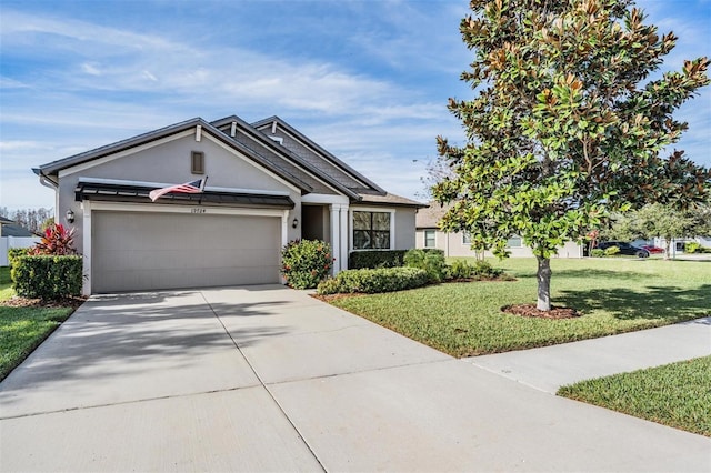 view of front of property featuring a garage and a front yard