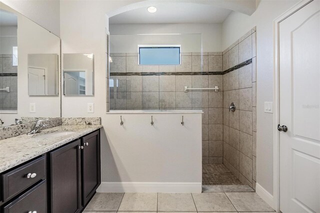 19724 Post Island Loop, Land O Lakes, FL 34638 - bathroom with vanity, a walk in shower, baseboards, and tile patterned floors