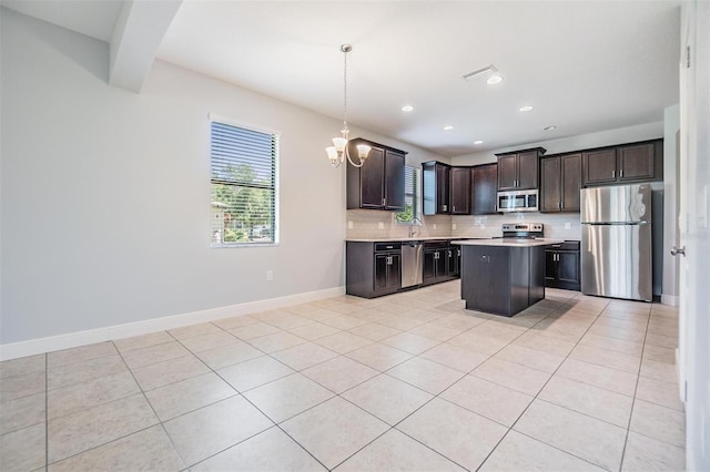 19724 Post Island Loop, Land O Lakes, FL 34638 - kitchen with appliances with stainless steel finishes, plenty of natural light, tasteful backsplash, dark brown cabinetry, and recessed lighting