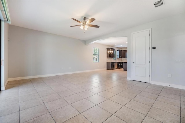 19724 Post Island Loop, Land O Lakes, FL 34638 - spare room with ceiling fan, light tile patterned flooring, a chandelier, baseboards, and arched walkways