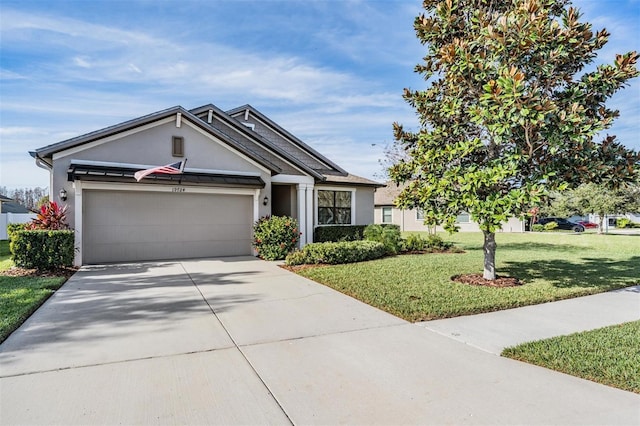 19724 Post Island Loop, Land O Lakes, FL 34638 - view of front of house featuring stucco siding, an attached garage, driveway, and a front yard