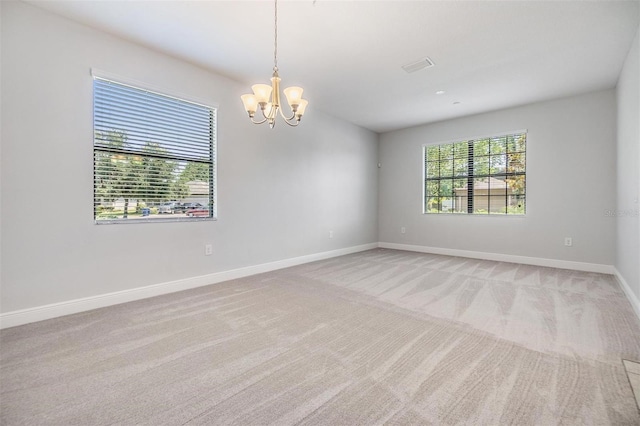 19724 Post Island Loop, Land O Lakes, FL 34638 - empty room featuring a chandelier, light colored carpet, and baseboards