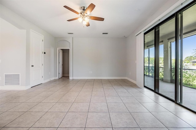 19724 Post Island Loop, Land O Lakes, FL 34638 - unfurnished room with a ceiling fan, light tile patterned floors, and baseboards