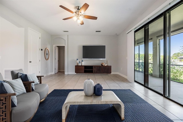19724 Post Island Loop, Land O Lakes, FL 34638 - living room featuring light tile patterned floors, ceiling fan, and baseboards