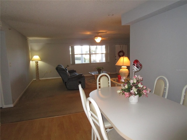 dining area with hardwood / wood-style flooring and ceiling fan