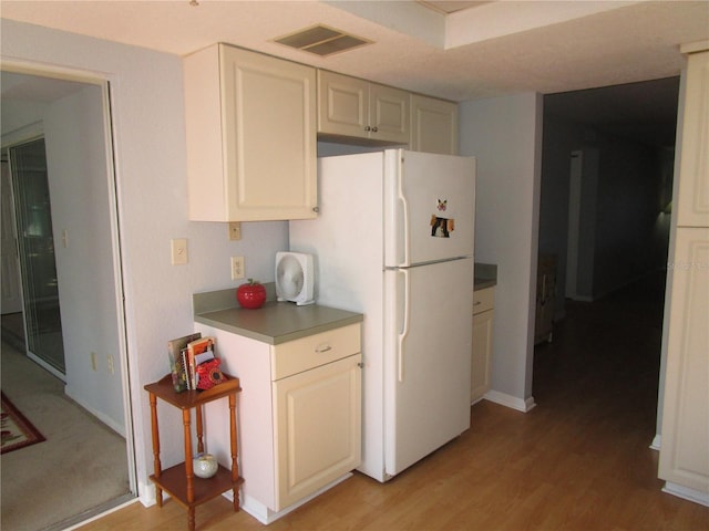 kitchen with white fridge and light hardwood / wood-style floors