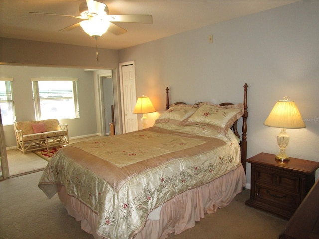 bedroom featuring light colored carpet, a closet, and ceiling fan