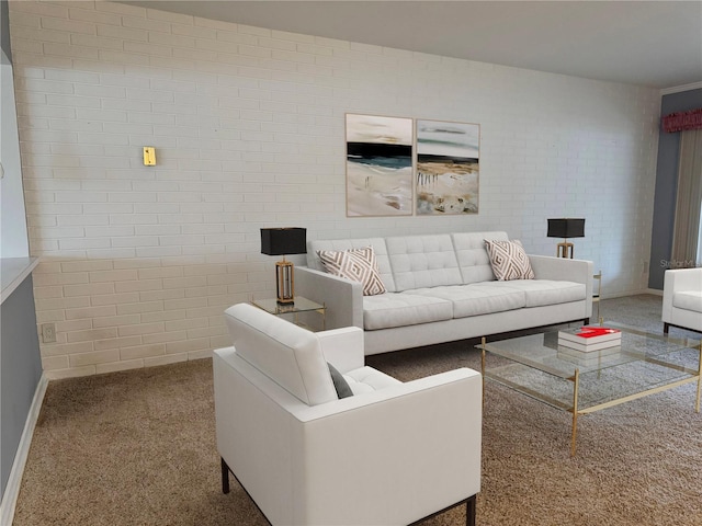 carpeted living room featuring brick wall